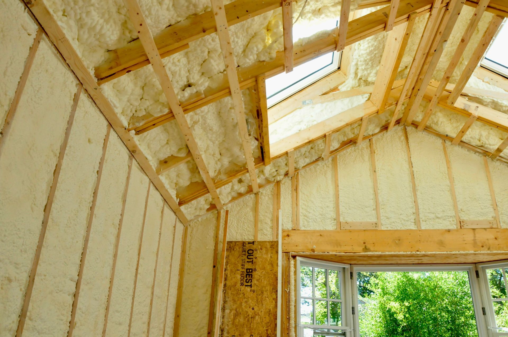 Room interior with spray foam insulation in the walls and cathedral ceiling