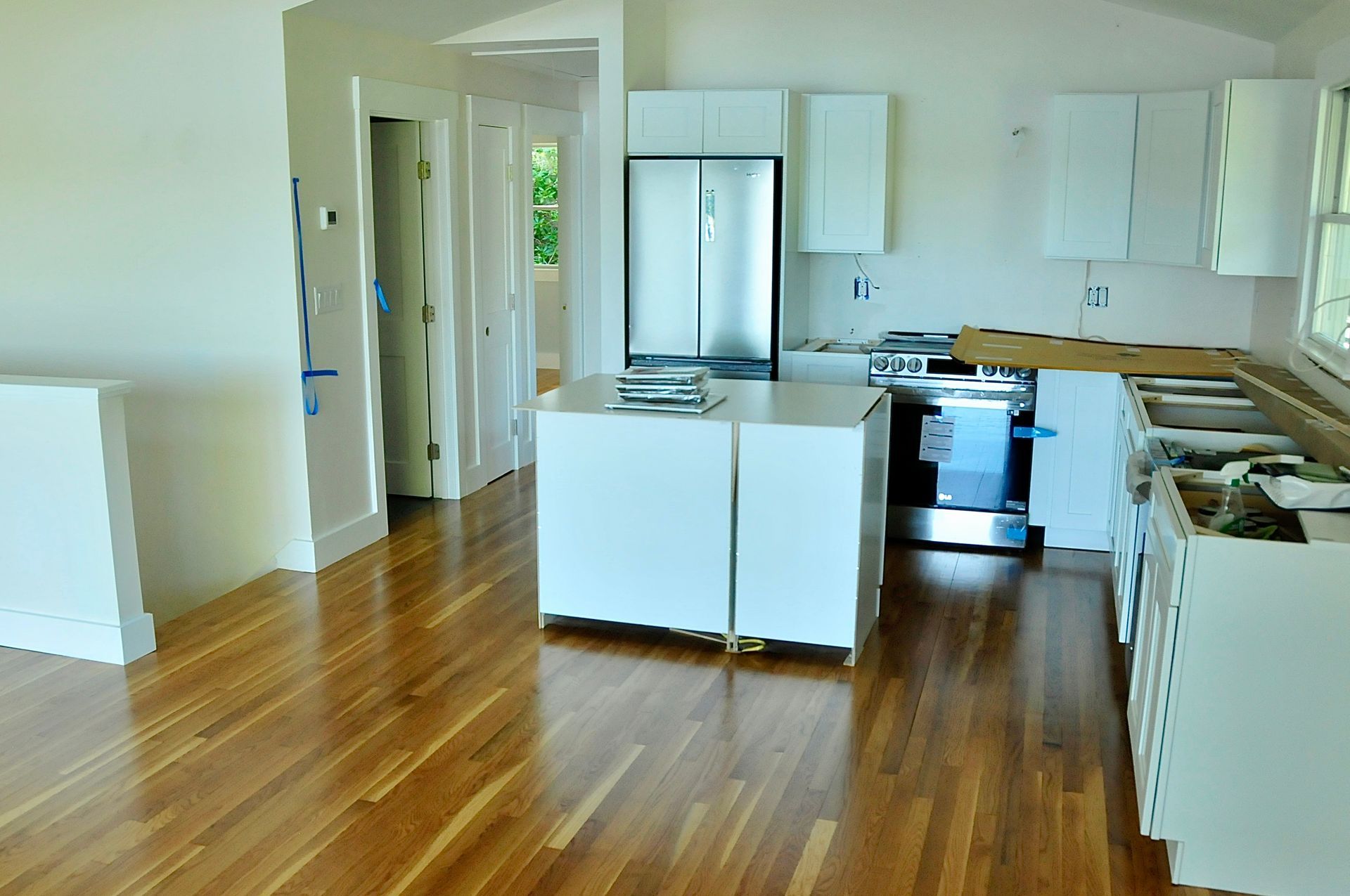 New hardwood flooring installed in a Cape Cod kitchen during cabinet installation
